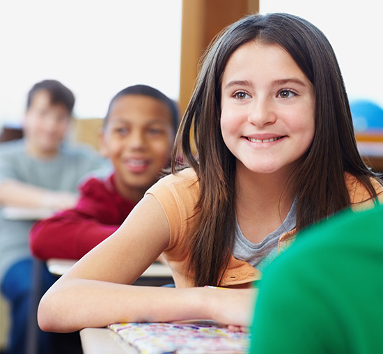 Girl with Asperger's / Autism Spectrum Disorder enjoying learning in school classroom